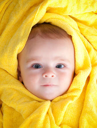 Cute little boy in a yellow scarfの写真素材