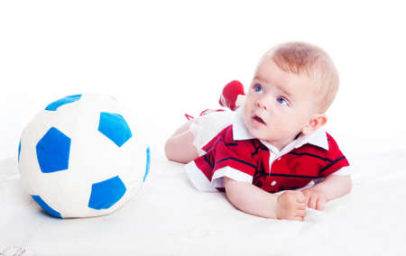 cute little boy with a soccer ball on a white backgroundの写真素材
