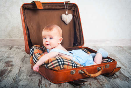 beautiful little boy in the old days a suitcaseの写真素材
