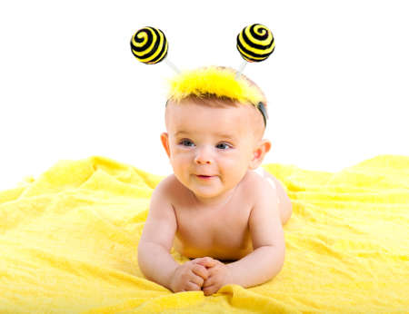 Cute baby boy lying on a yellow scarfの写真素材