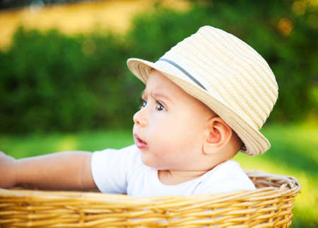 The little boy with a hat in a basketの写真素材