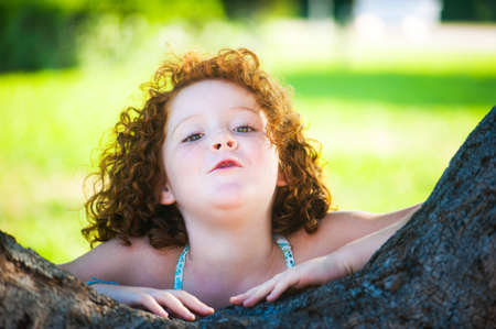  red-haired girl is played outdoorsの写真素材