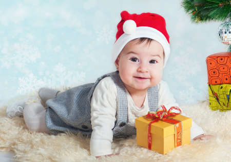 Sweet girl with a gift in a red cap