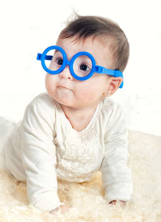 Funny 6 month old baby girl in glassesの写真素材