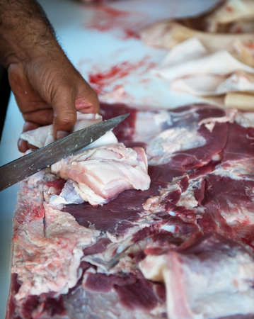 closeup of a man's hand butchering pigsの写真素材