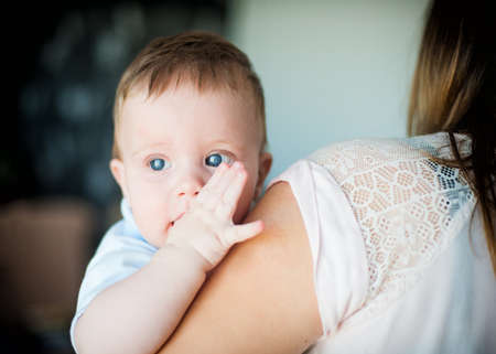 Photo Cute little boy on mother's handsの写真素材