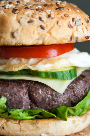 Hamburger on a wooden background with tomatoの写真素材
