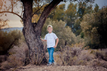 Portrait of a cute boy on the background of natureの写真素材