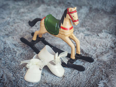 Children's shoes and children's toy rocking horseの写真素材