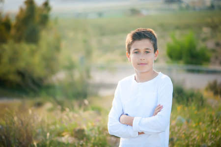 Portrait of a cute boy on the background of natureの写真素材