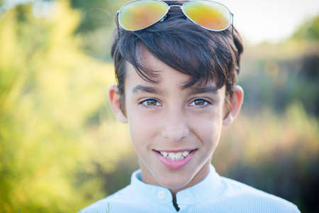 Portrait of a cute boy on the background of nature