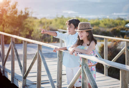 Funny beautiful boy and girl on the background of nature
