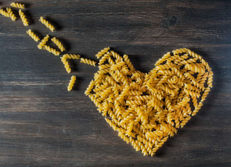 built the heart of pasta on the wooden backgroundの写真素材
