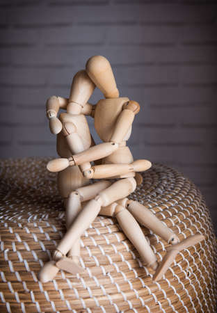 Two Lovers wooden man tenderly cuddling indoorsの写真素材