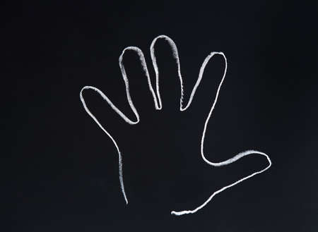 Painted hand on the blackboard to write
