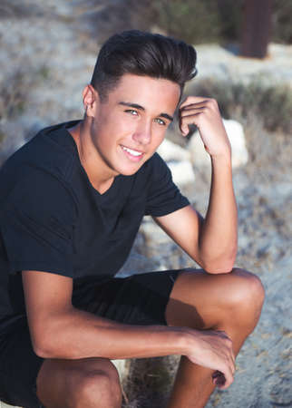 Portrait of a young guy with a nice appearance on the background of natureの写真素材