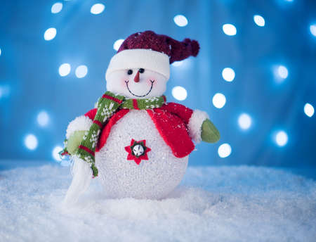 cute snowman toy on a blue background withの写真素材