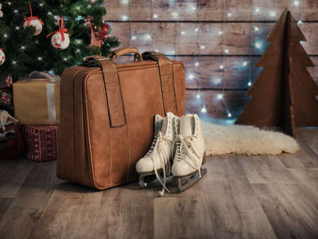 Vintage ice skates for figure skating with fir tree branch hanging on rustic background. Christmas decoration.の写真素材