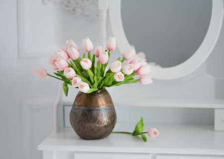 Artificial tulips on a table with a mirrorの写真素材