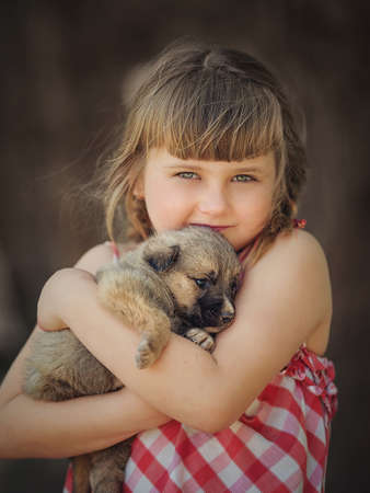 Cute child resting with dogの写真素材