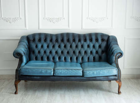 Beautiful antique blue sofa on a light backgroundの写真素材