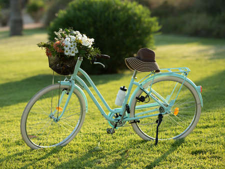 Beautiful blue bike with a basket of flowersの写真素材
