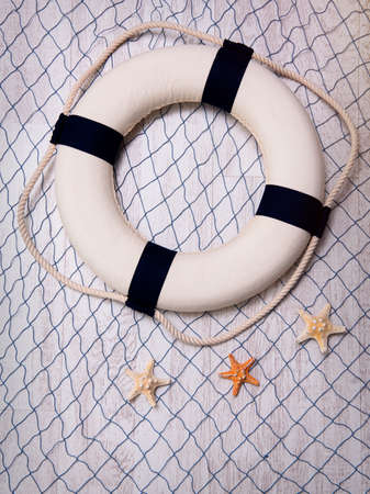 Lifebuoy on a blue grid over white background.の写真素材