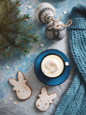 Enameled cup with whipped cream on a rustic background with beautiful Christmas lights in the form of a side. There may also be coffee. view from above.の写真素材
