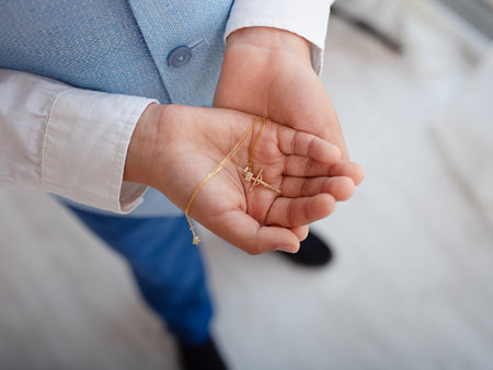 A Catholic cross is in children's hands