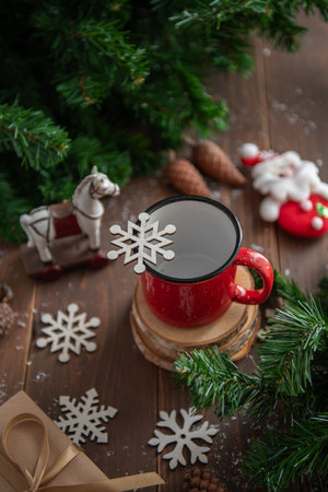 New Year's background: red mug with New Year's caramel, pine branches, pastel background, bokeh.の写真素材