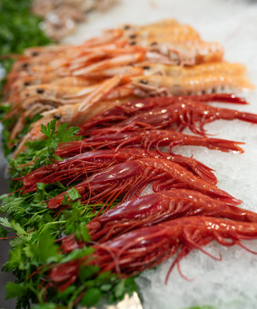 Frozen, boiled shrimp. Texture background. Seafood on the counter. Fish market. Close-up shot of...