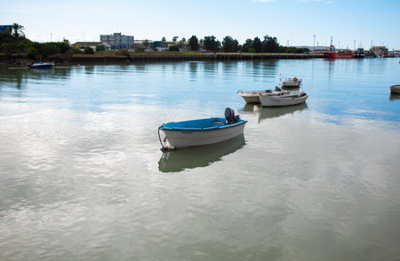 Gadiz, Spain - June 02, 2025: a lone boat on a lake in the evening