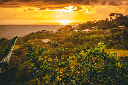 Amazing view from mountains in Costa rica to ocean and sunset during a summer rain. High quality photoの写真素材