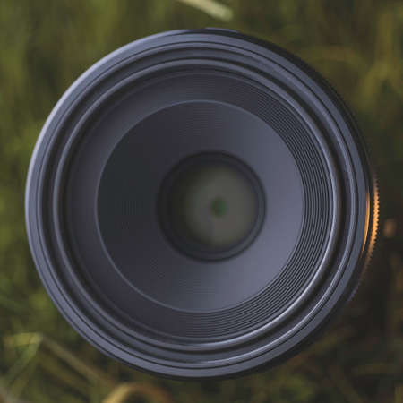 Macro camera lens in grassの写真素材