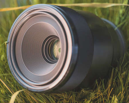 Macro camera lens in grassの写真素材