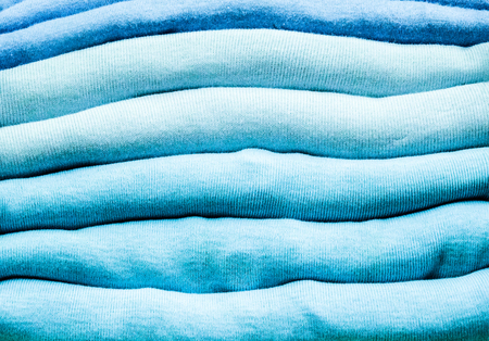 A pile of colorful clothes on top of each other with fabric detailsの写真素材
