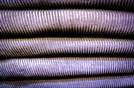 A pile of colorful clothes on top of each other with cord fabric detailsの写真素材