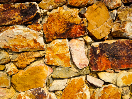 Dry sandstone wall with orange and brown colorsの写真素材