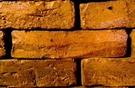 Thin clay glazed brick layed on top on each otherの写真素材