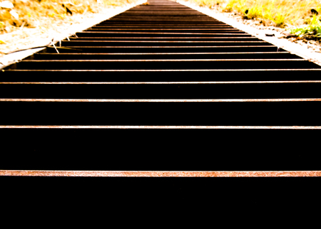 Horizontal metal lines of a steel grid that has rusted going to the distanceの写真素材