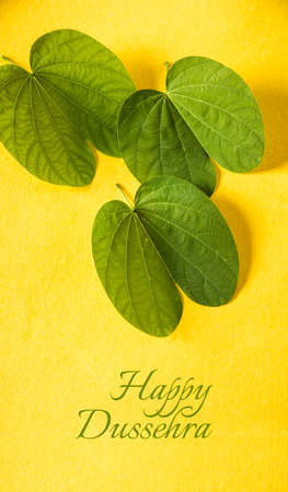 indian festival dussehra, showing golden leaf with traditional indian sweets pedha in silver bowl, Dussehra greeting cardの写真素材