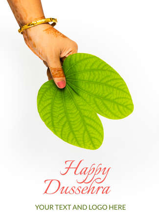 indian festival dussehra, showing golden leaf with traditional indian sweets pedha in silver bowl, Dussehra greeting cardの写真素材