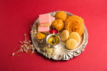Indian snacks with condiments served in an aluminium trayの写真素材