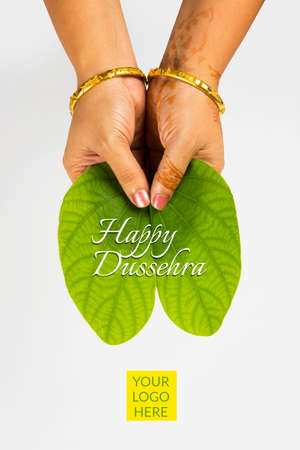 indian festival dussehra, showing golden leaf with traditional indian sweets pedha in silver bowl, Dussehra greeting cardの写真素材
