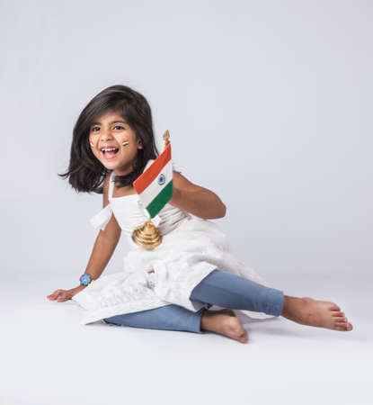 indian flag and cute little indian girl, 4 year indian girl with indian flag or tricolour, india flag & girl, girl holding indian flag, indian independence day, indian republic day, isolated on whiteの写真素材