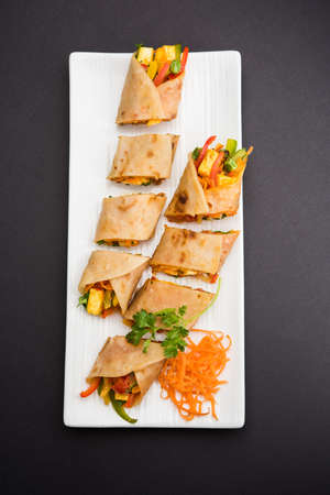 Indian popular snack food called Vegetable spring rolls or veg roll or veg franky or veg wrap made...