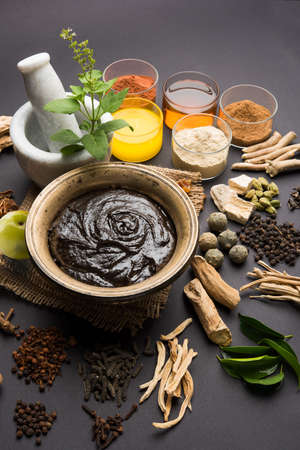 Close up of an Indian Ayurvedic dietary supplement called Chyawanprash / chyavanaprasha on dark grey backgroundの写真素材