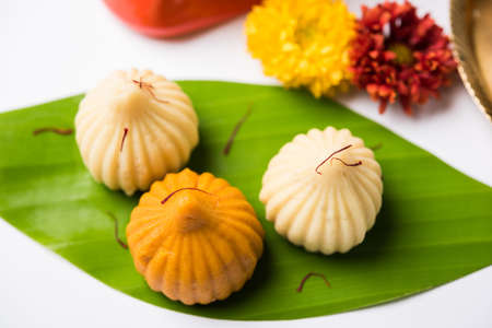 A modak is an Indian sweet dumpling popular in many parts of India. It is called modak in Marathi and Konkani as well as Gujarati language, Kozhakkatta in Malayalam, modhaka or kadubu in Kannadaの写真素材