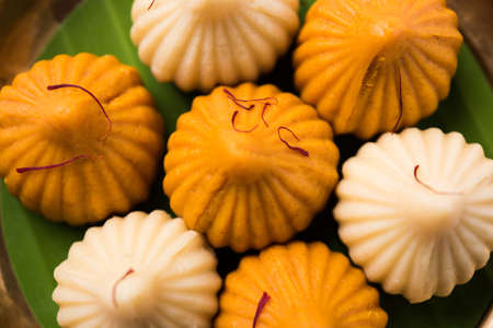 A modak is an Indian sweet dumpling popular in India. It is called modak, Kozhakkatta, modhaka, kadubu, modhakam, kozhakkattai, kudumu. made up of coconut and jaggery, rice flour, wheat with khavaの写真素材
