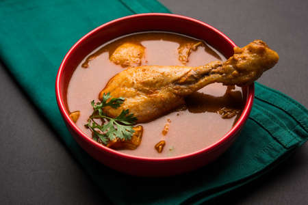 Indian spicy Chicken curry or masala chicken with prominent leg piece, popular recipe from India,...